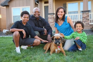 Family and Dog on grass of house.