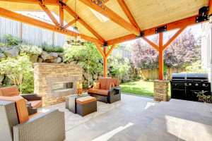 Exterior Covered Patio With Fireplace And Furniture.