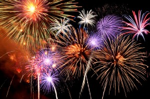 Fireworks of various colors bursting against a black background