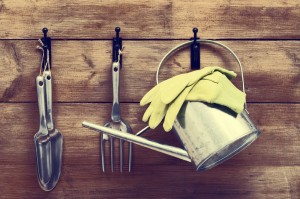 gardening tools hanging on wooden wall