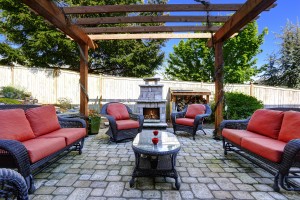 Bold paver patio with pergola and outdoor firelplace.