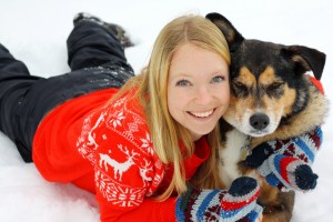 Woman Hugging German Shepherd Dog In Snow