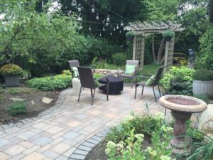 Brick paver walkway and patio with a fire pit.