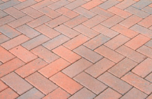 Close up of a professionally laid brick paver walkway.