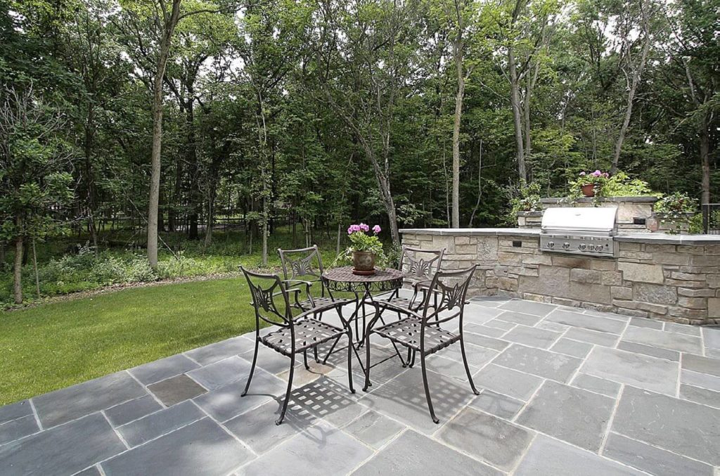 Beautiful stone paver patio with table and chairs