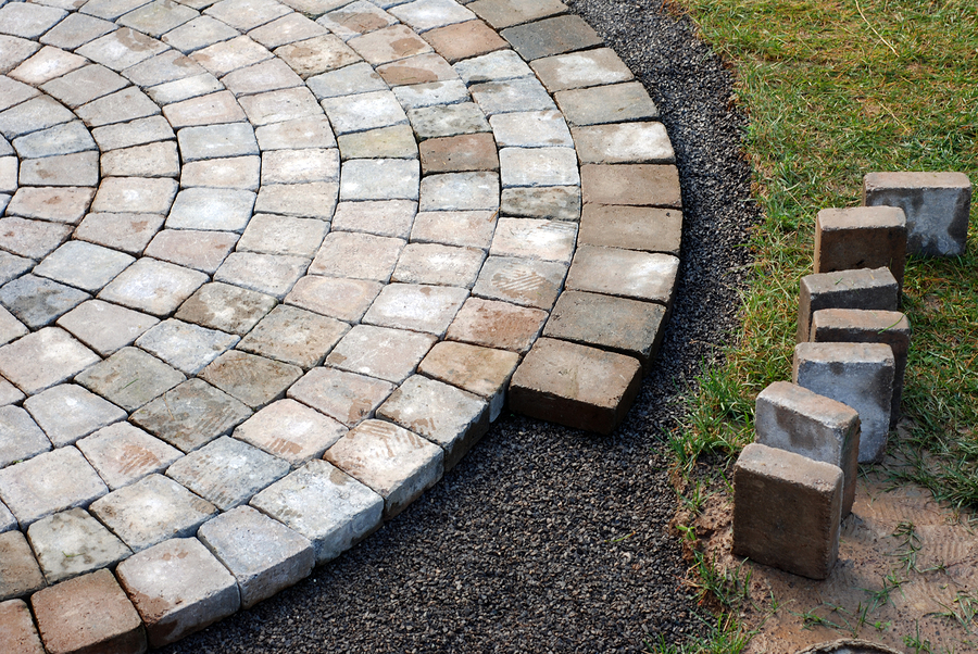 Paver patio being installed in a circular pattern.