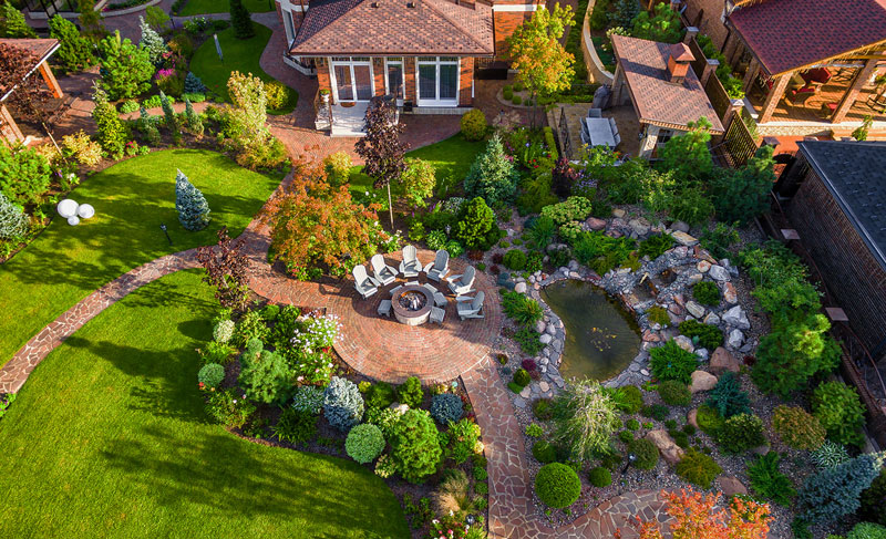 Landscape maintenance services with Twin Oaks Landscape in Ann Arbor Michigan. The beautifully maintained hardscaped firepit area and surrounding garden make this a peacful place for the homeowners to relax and unwind.
