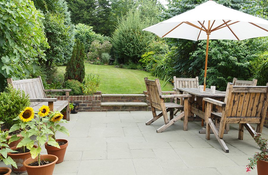 Upscale backyard private patio with lush landscape.