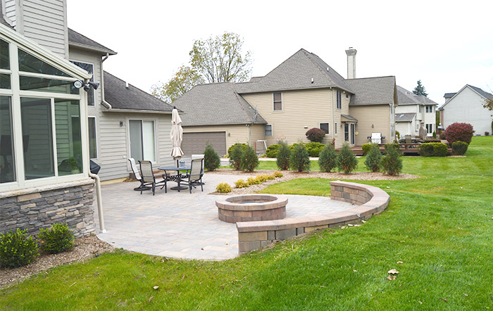 backyard paver patio with fire pit and seating