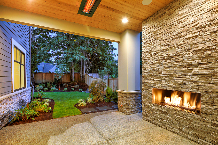 Nice new landscape design with a patio and outdoor fireplace.