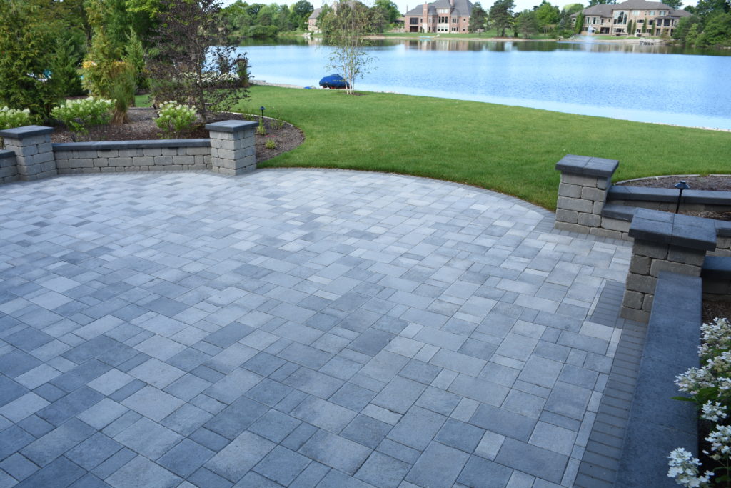 Beautiful view of pond off the edge of a new paver patio.