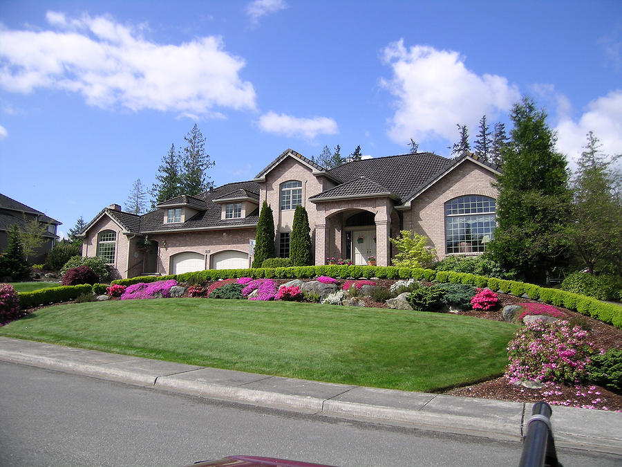 beautiful luxury mansion with well manicured landscaping