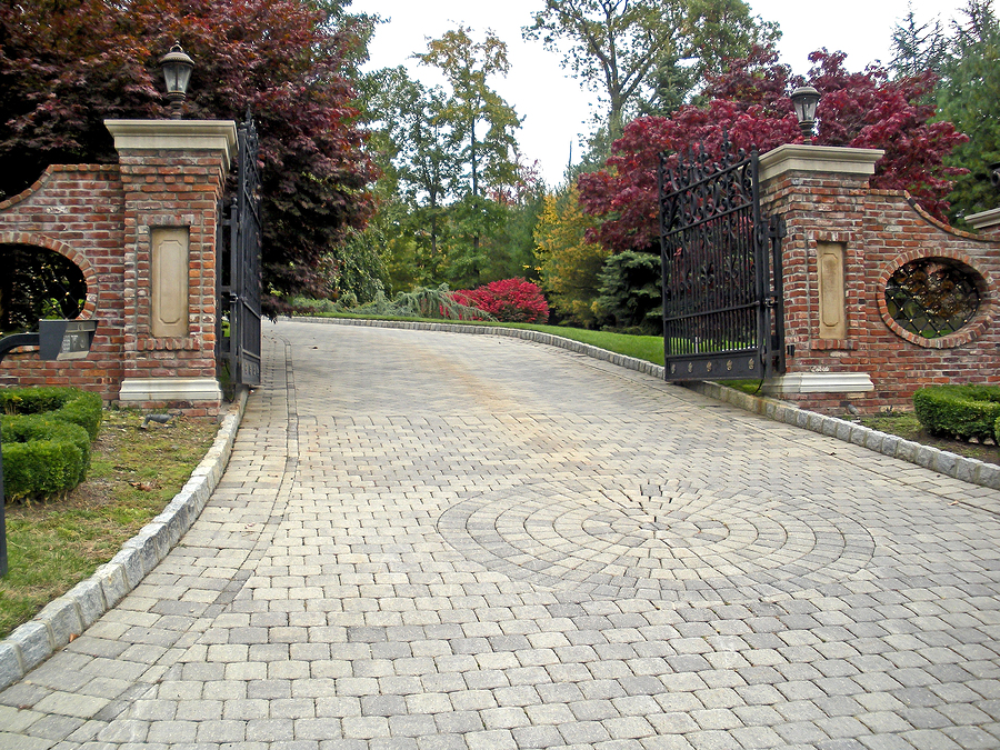 Grand entrance with custom designed driveway made out of high quality pavers.