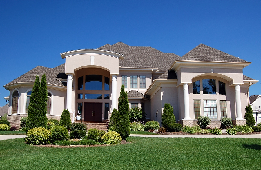 Luxury home with beautiful landscape in the front yard.