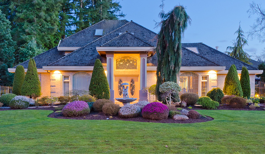 Luxury house at dusk with garden landscape design..