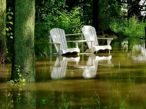 Lawn chairs in a flooded yard