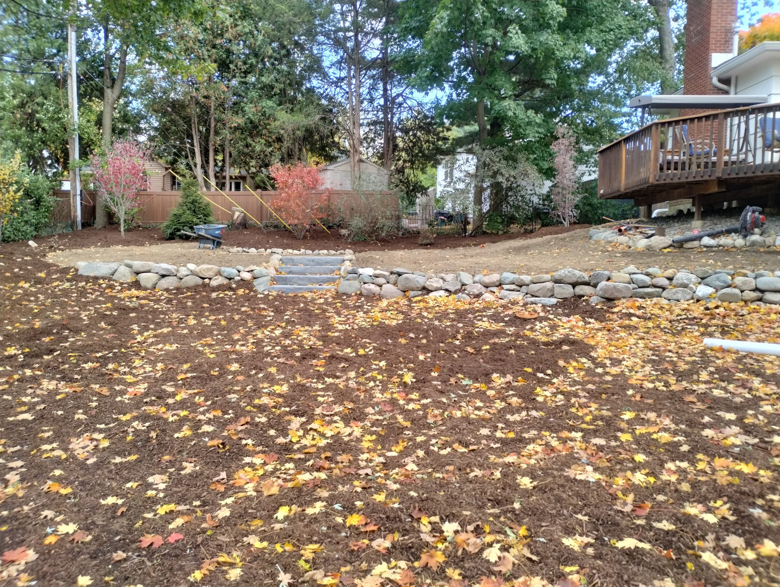 End result of backyard renovation with new landscape and tiers with addition of second steps.