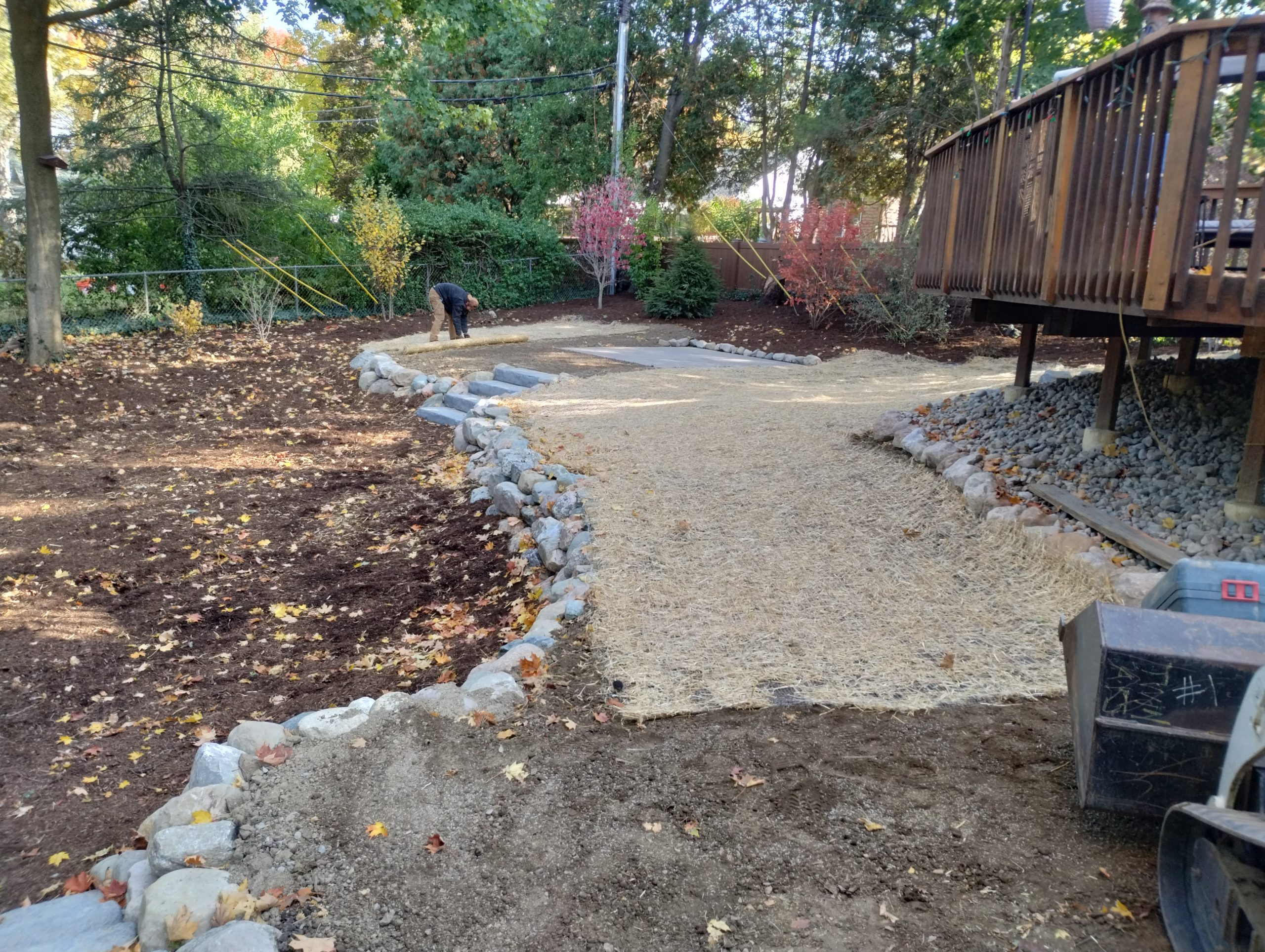 End result of backyard renovation with new landscape and tiers-photo of behind the deck. 