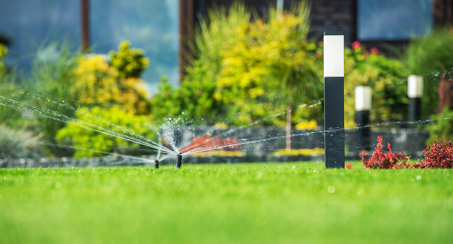 automatic pop-up irrigation system spraying lawn