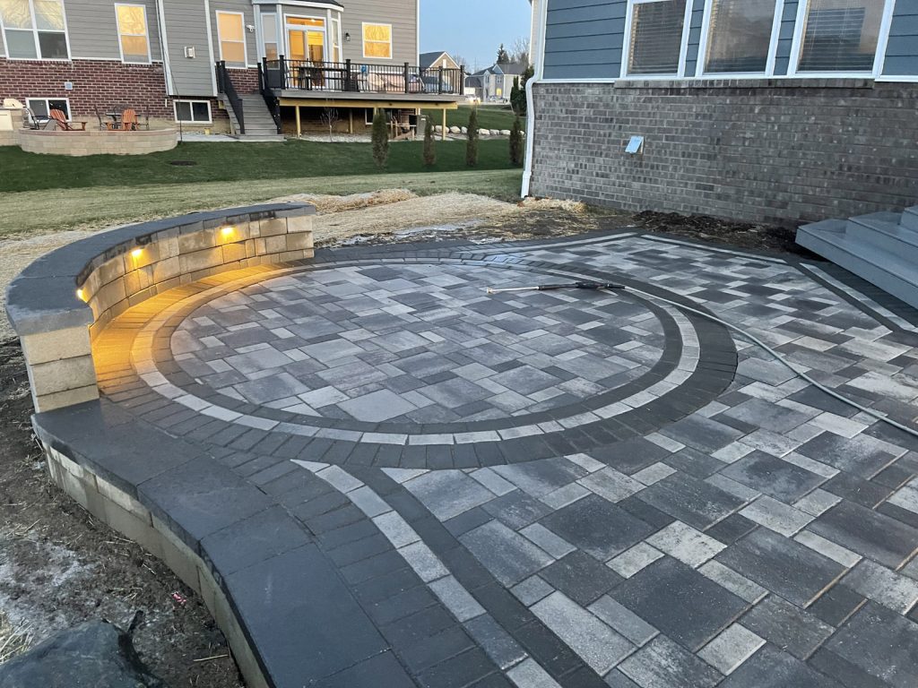 Multi Color Paver patio design with intricate design in a circle and border in Ann Arbor