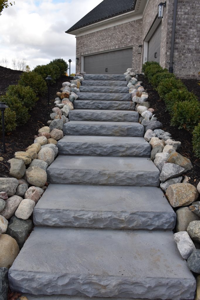 Stone terraced steps enclosed by rock border in Ann Arbor