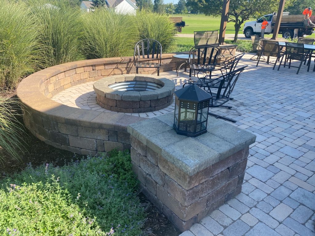 Patio area with round fire pit and terraced seating
