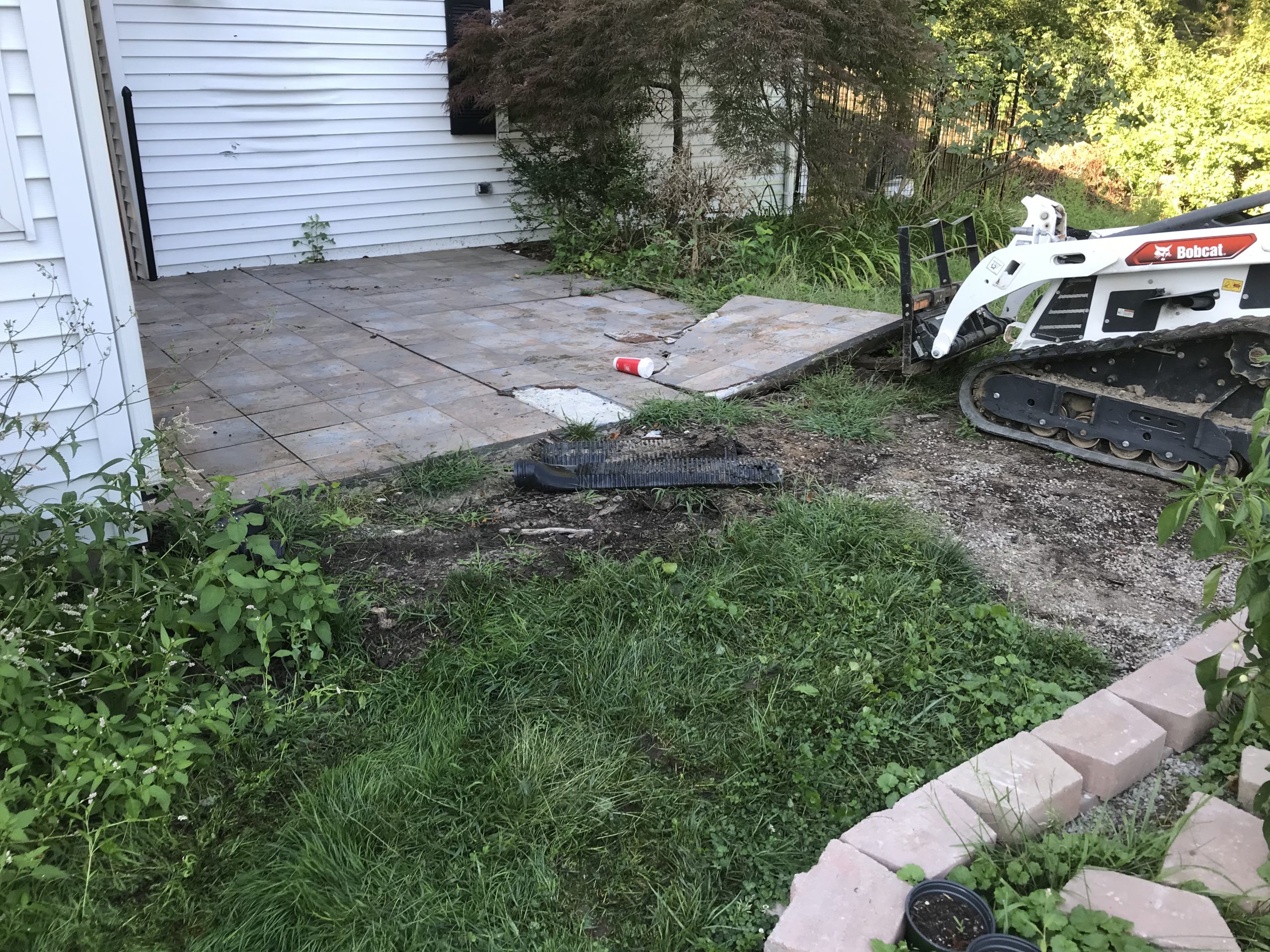 Broken old patio being removed.