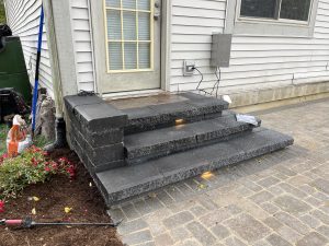 modern stone steps leading up to back door from porch