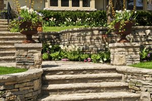 Natural stone landscaping in front of a house.